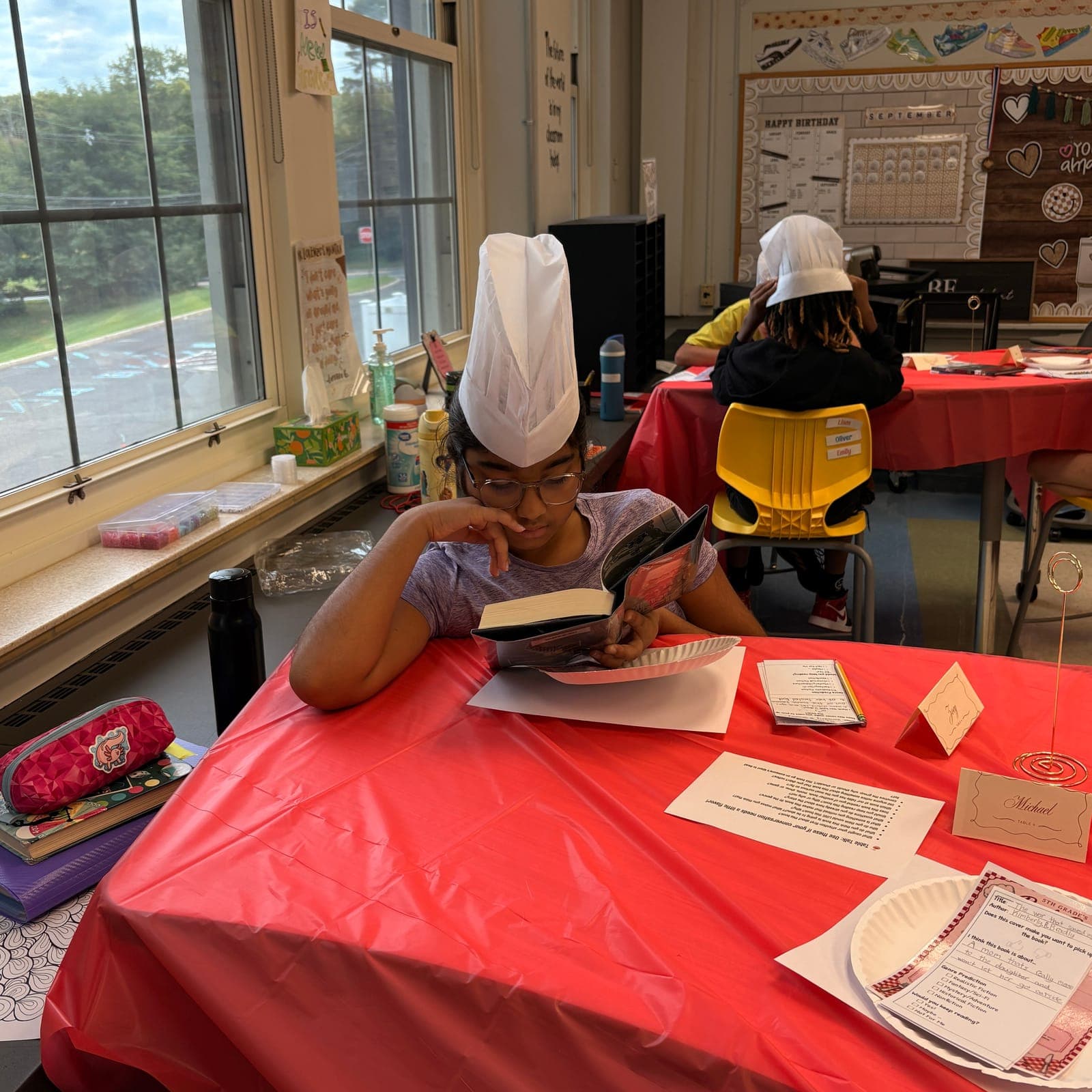 A student samples a book at Central School’s Book Bistro.